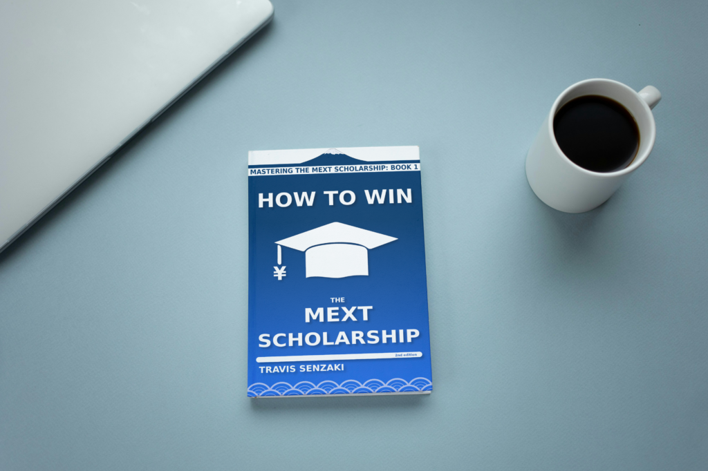 How to Win the MEXT Scholarship book sitting on table with coffee